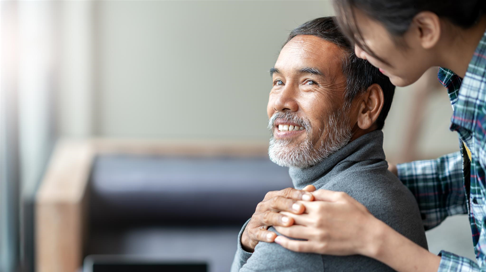 younger woman comforting older man