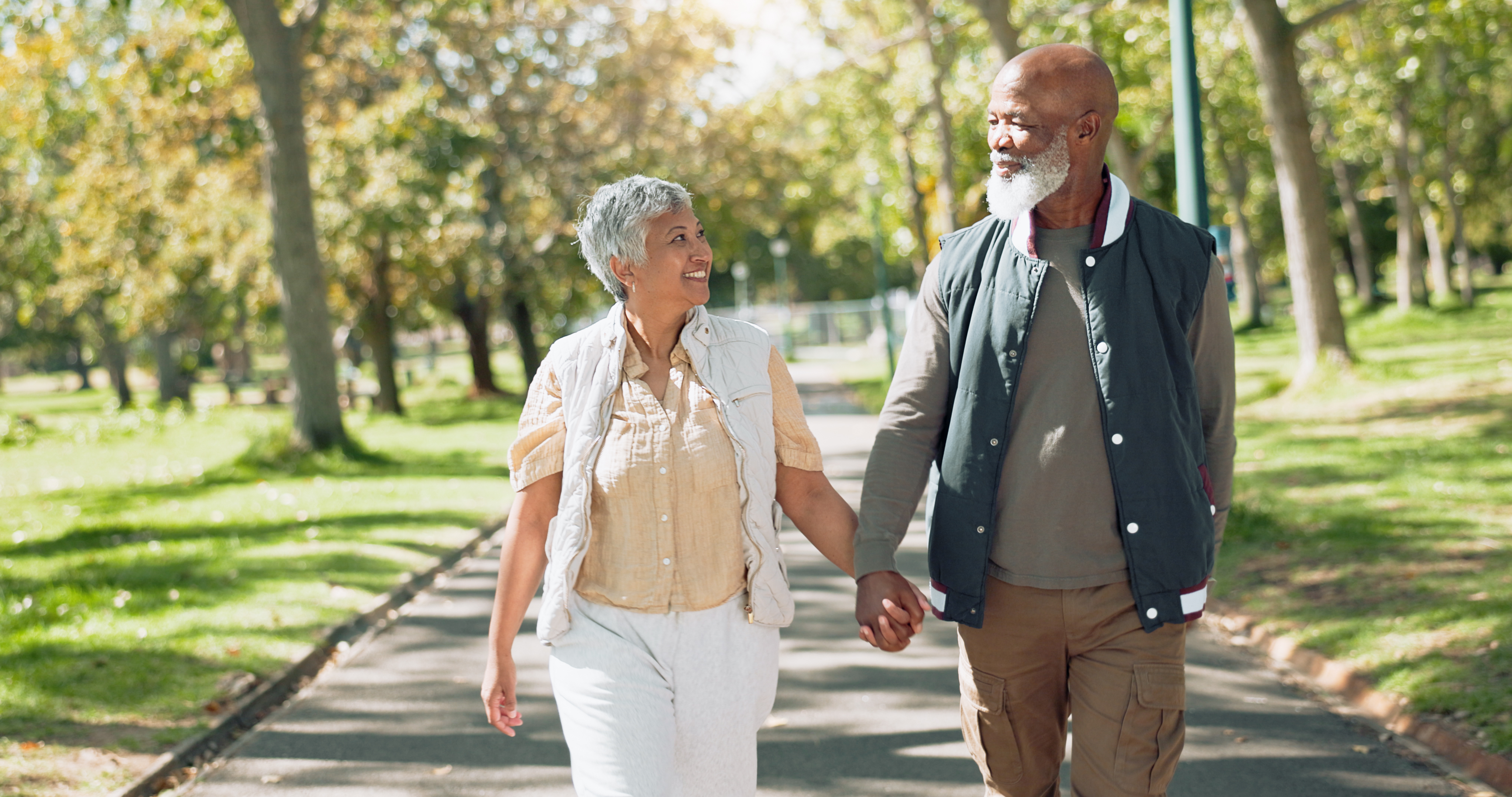 Older couple walking outside and holding hands