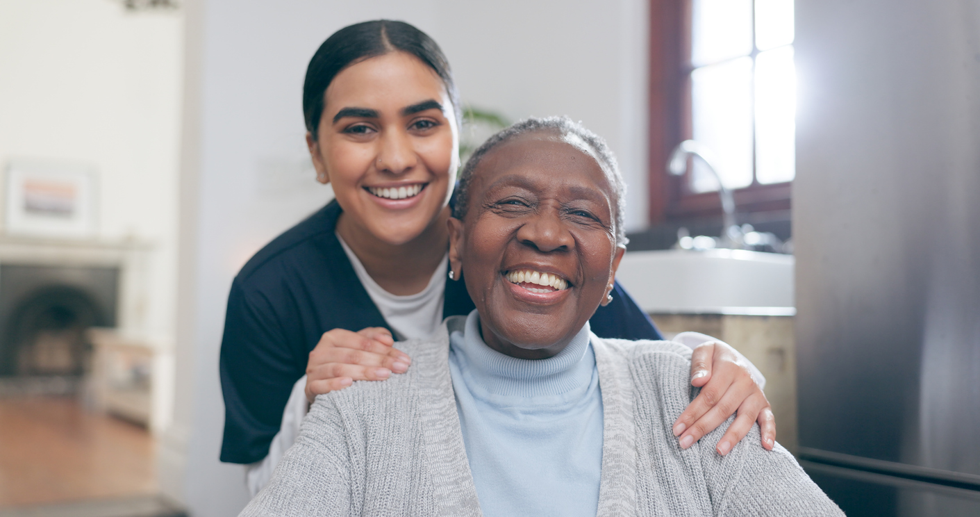 young nurse smiling behind an older woman